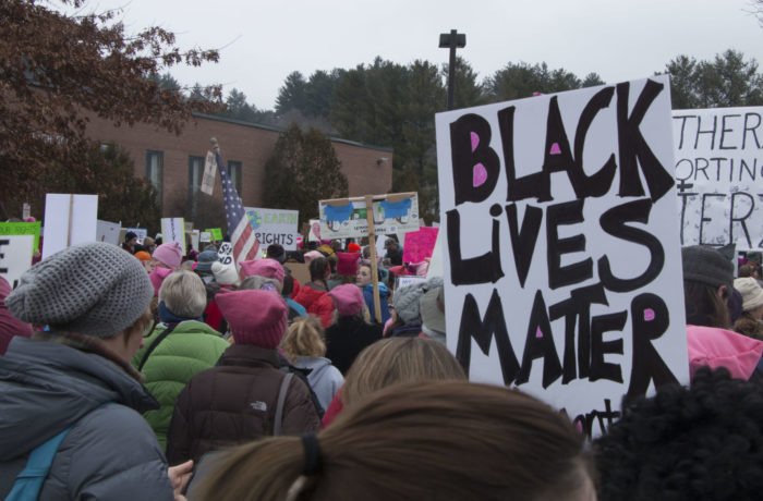 Attendees of the Women's Marchon Montpelier on Jan. 21, hold up a "black lives matter" sign while waiting for the march to begin.