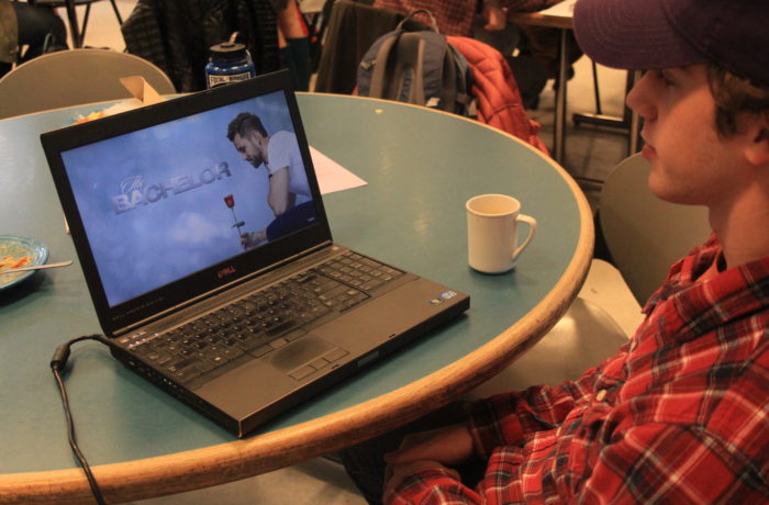 Dan Ramos, '17, uses his lunch break to catch up on the bachelor. Photo illustration by Mady Hansen.