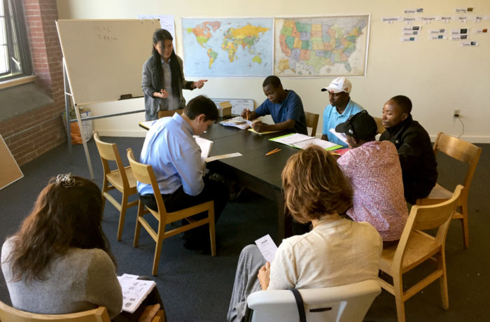 Three adult refugee-background learners from Somalia and the Democratic Republic of Congo are taught English by St. Michael’s College students as a part of the MATESOL graduate program at the Winooski Mill.