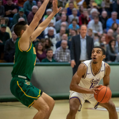 Levi Holmes ’19 being defended during an exhibition game at Univ. of Vermont, Nov. 4, 2018. (Photo via Jaems Buck/SMC Athletics)